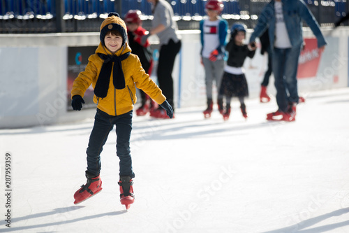 Happy boy with hat and jacket, skating during the day, having fun . © Tomsickova