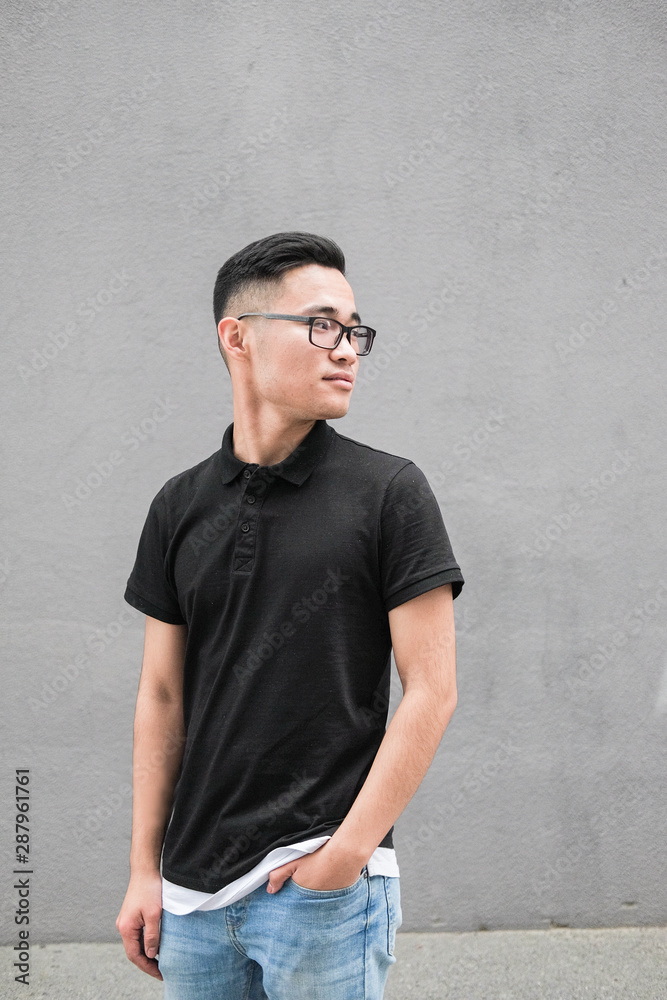 Korean man in a black t-shirt. Asian man with glasses. Korean man in a black t-shirt. Asian man with glasses.