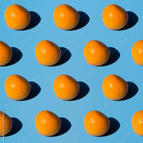 Fresh mangoes pattern on a light blue background. Isometric view with hard lights. Natural bio fruits concept