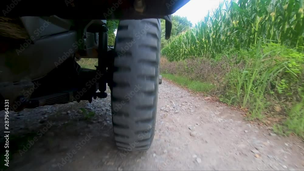 military jeep 4x4 car driving on dirt road, close up of wheel military jeep 4x4 car driving on dirt road, close up of wheel
