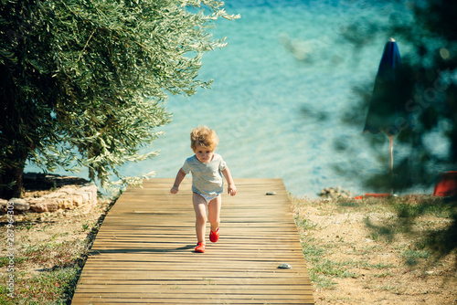 Sea jorney. Problems and difficulties on the road. Difficult journey. Holiday obstacles. Sad kid on the beach. © Tverdokhlib