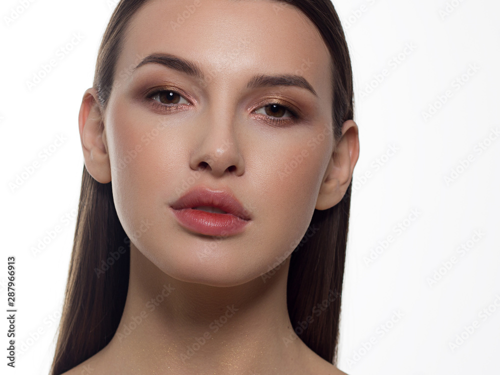 Fototapeta premium Close-up portrait of a beauty woman with full lips, straight hair and perfectly clean skin. Daytime makeup, styling and soft care. Skin care in the spa salon or cosmetology, smooth eyebrows