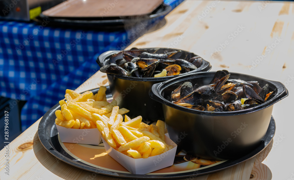 Traditional dish on Lille Braderie, mussels and fries (moules frites).Great Lille  Braderie (Braderie de Lille). Photos | Adobe Stock