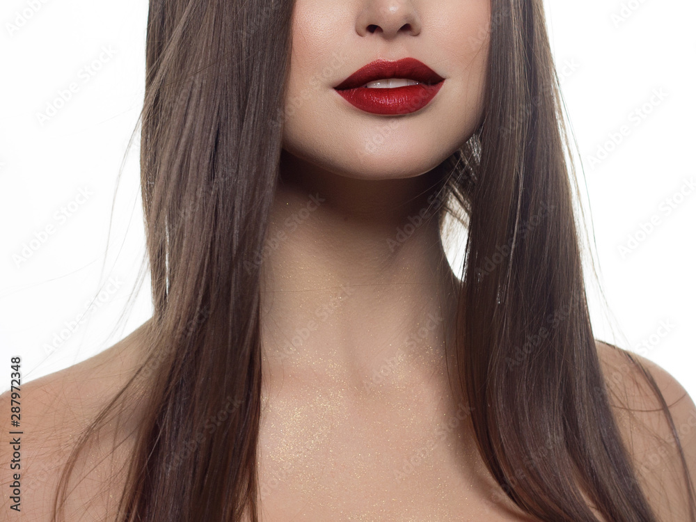 Cosmetics, makeup and trends. Bright lip gloss and lipstick on lips. Closeup of beautiful female mouth with red lip makeup. Beautiful part of female face. Perfect clean skin in red light Cosmetics, makeup and trends. Bright lip gloss and lipstick on lips. Closeup of beautiful female mouth with red lip makeup. Beautiful part of female face. Perfect clean skin in red light