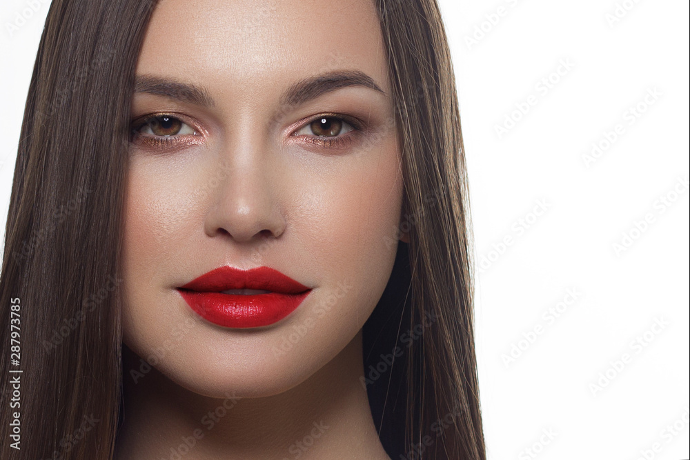 Close-up portrait of sexy european young woman model with classic glamour make-up and pink lipstick. Dark long hairstyle, christmas makeup, dark eyeshadows, bloody red lips with gloss
