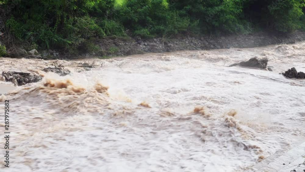 Dams or weir with strong and dangerous water flows After heavy rain on a mountain that is a rain forest. Dams or weir with strong and dangerous water flows After heavy rain on a mountain that is a rain forest.