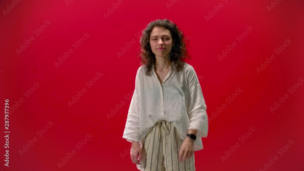 curly girl smiles on a red background smiles curly girl smiles on a red background smiles
