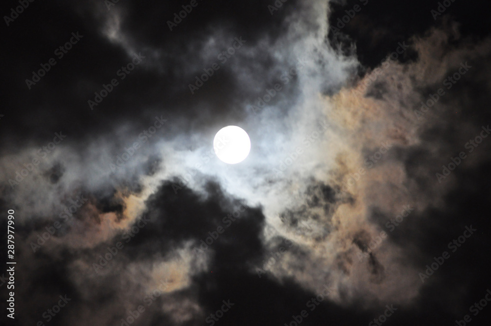 Super Full Moon with clouds at Night, Dramatic cumulus clouds in the moonlight