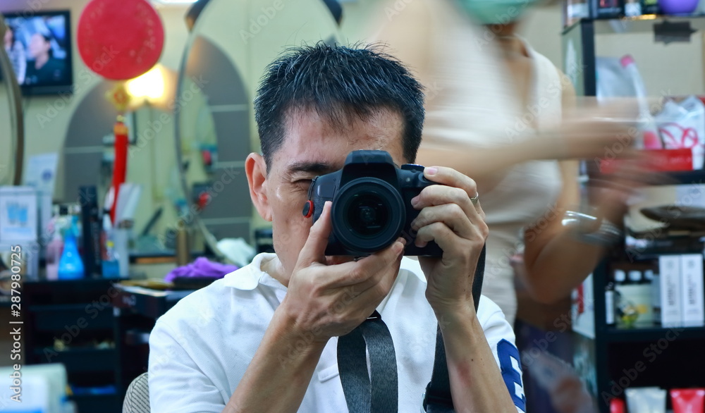 Closeup face in the mirror with DSLR camera while having a hair cut, self portrait Closeup face in the mirror with DSLR camera while having a hair cut, self portrait