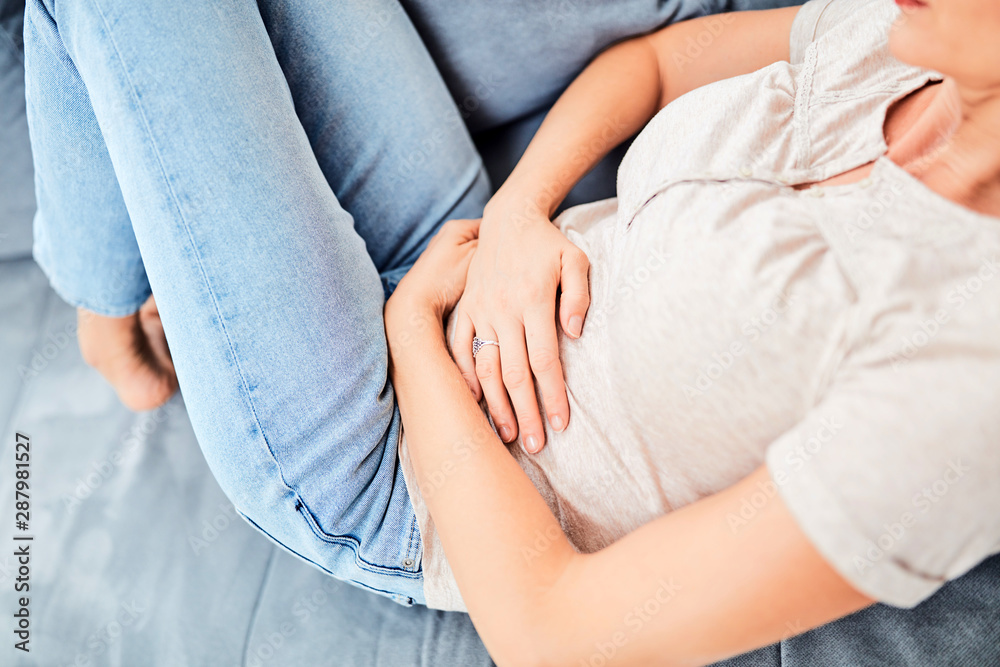 Woman with stomach issues / problems while lying on the couch. Woman with stomach issues / problems while lying on the couch.