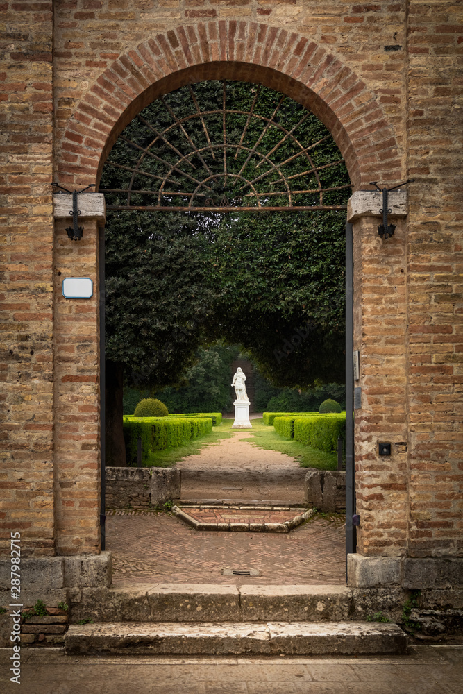 Arc gate to the historical Park in San Quirico, Italy