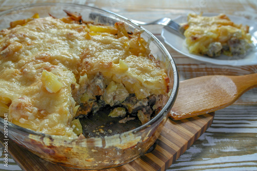 Ready meal - the Orlov-style meat with a piece cut off on a white plate. Freshly prepared dish with cut and close-up layers.