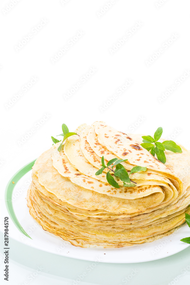 many fried thin pancakes in a plate, on white background. many fried thin pancakes in a plate, on white background.