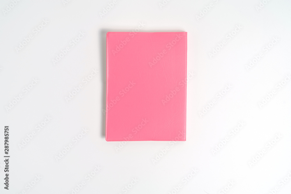 Pink notebook on white desk. Business minimal concept for women. Flat lay, top view, copy space Pink notebook on white desk. Business minimal concept for women. Flat lay, top view, copy space