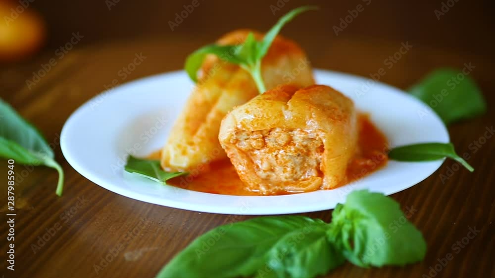 stuffed pepper with meat and vegetable sauce in a plate stuffed pepper with meat and vegetable sauce in a plate