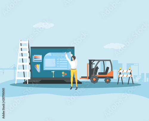 builder and laptop with webpage under cosntruction photo