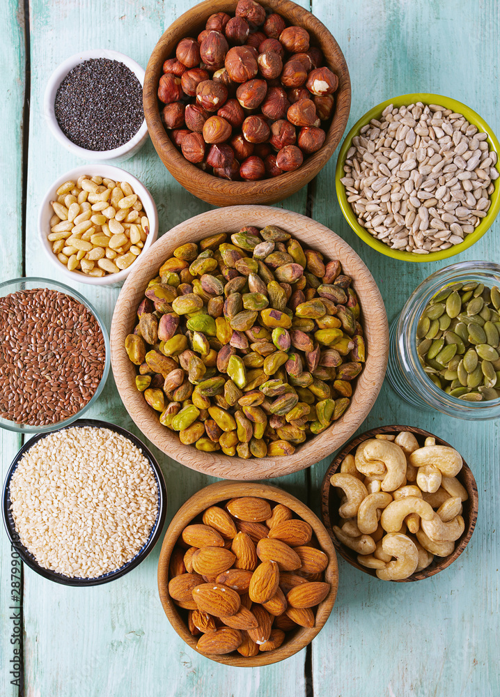 nuts, seeds and dried fruis on wooden surface nuts, seeds and dried fruis on wooden surface