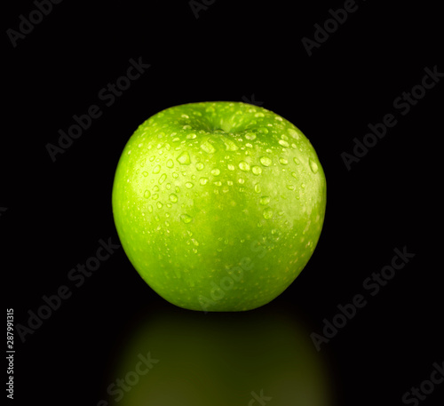 Green fresh Apple with leaf on black background