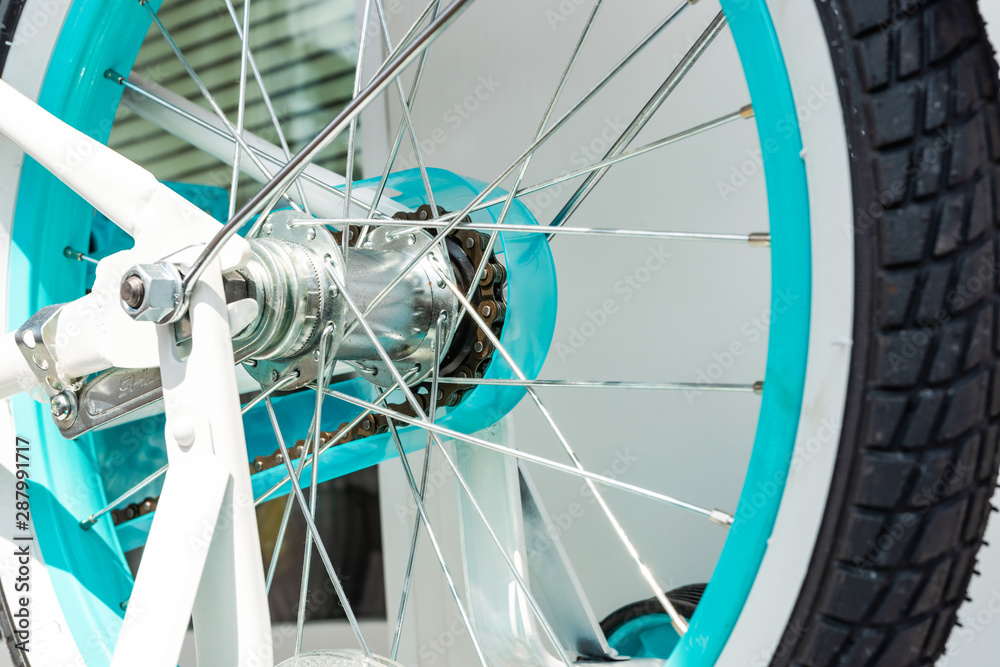 Rear wheel from bicycle with turquoise rim