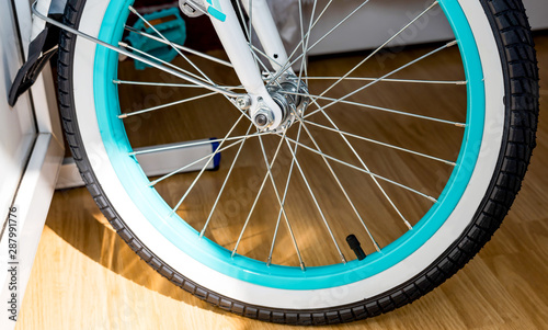 Bicycle wheel with metal spokes and turquoise rim