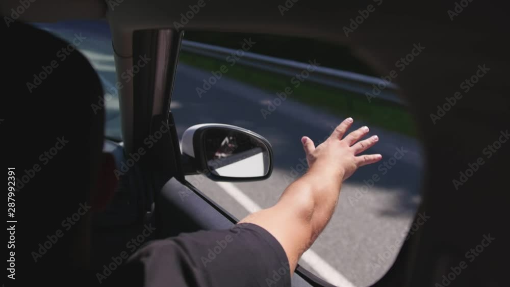 Man puts his hand out car window, feels the fresh air, on a sunny day. Close up shot. Man puts his hand out car window, feels the fresh air, on a sunny day. Close up shot.
