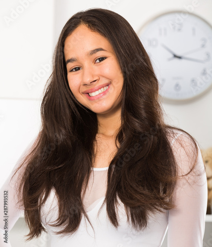 Positive teenager girl smiling at home photo