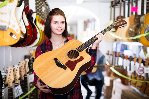 Teenager choosing acoustic guitars