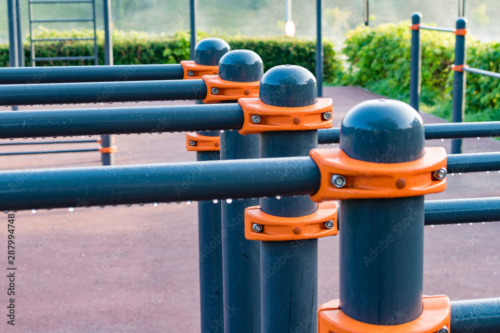 Wet bars on sports field with an orange mount in the morning Wet bars on sports field with an orange mount in the morning
