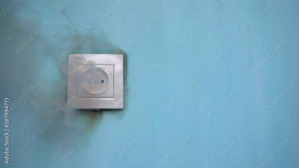 Apartment fire is caused by electrical outlet faults. Burnt and damaged electric plug socket from overload short circuit. 