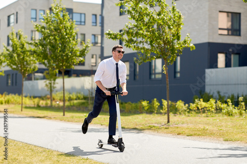 business and people and concept - young businessman riding electric scooter outdoors © Syda Productions