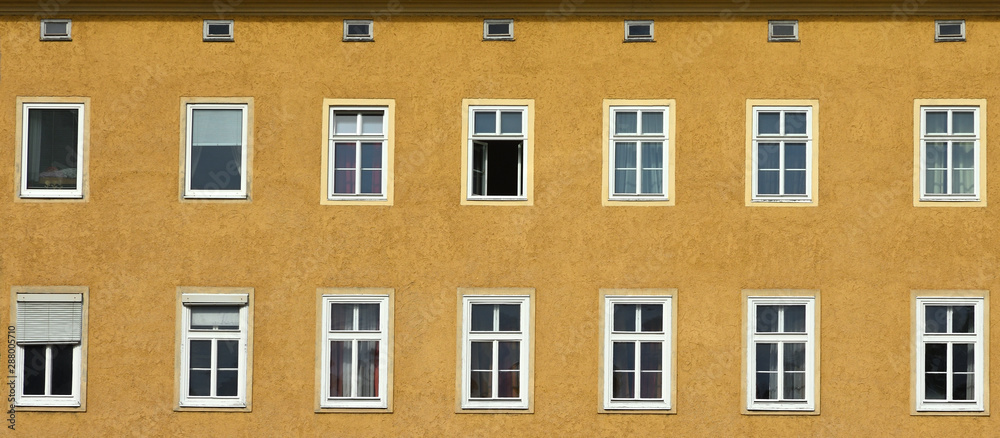 Panorama view of lots of windows on a yellow building