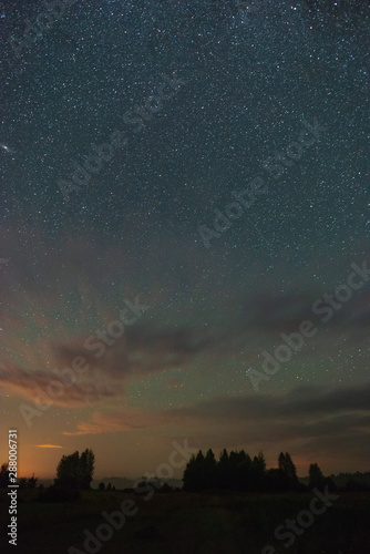 Starry sky over the forest over the fields and forests summer night and far from the city