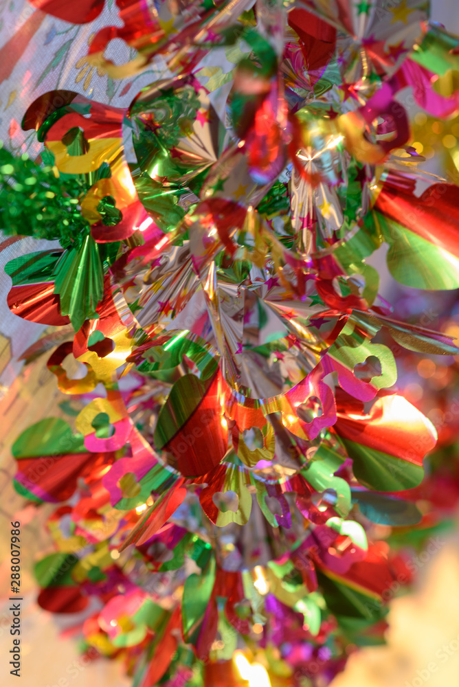 Colorful shiny garland at sunset light.Image For Illustration Celebrate Christmas in warm destinations.Festive Decor Beach, Pool, Summer or Winter vacations and Sukkah in Sukkot holiday decoration.