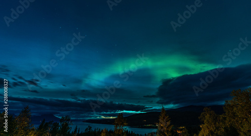 Ursa Major constellation, Aurora Borealis and heavy clouds over Norwegian mountains around Rossvatnet Lake, Northern Norway. Late summer night. © Alexandre Patchine