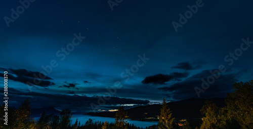 Ursa Major constellation, heavy clouds over Norwegian mountains and Rossvatnet Lake, Northern Norway. Late summer night. Long exposition photo