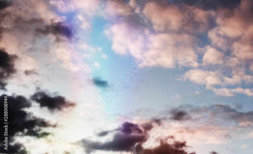Fluffy pink clouds against a blue sky at sunset