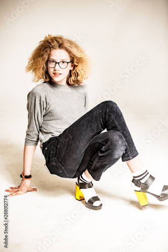 Young Girl with golden High heels photo