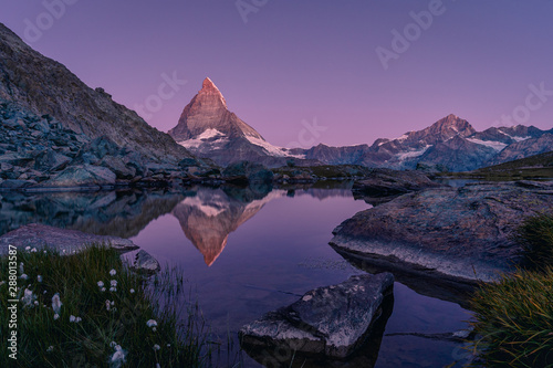 The world famous Matterhorn (Mont Cervin) reflected in the Riffelsee during dawn, blue hour, Zermatt, Switzerland, Alps