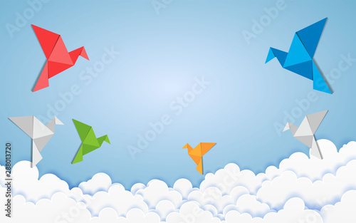 Origami made colorful bird with origami clouds. Paper art and craft style