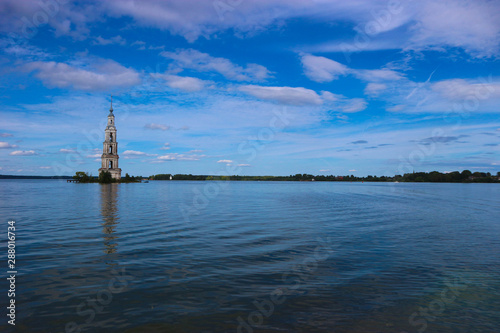 Landscape with flooded belfry Kalyazin Bell Tower under blue sky © Sergei Timofeev