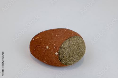 House at Covehithe near Lowestoft falling into the sea as a result of cliff erosion, creating this pebble from one of the house bricks and mortar joint. Found on the beach near the ruin.. photo