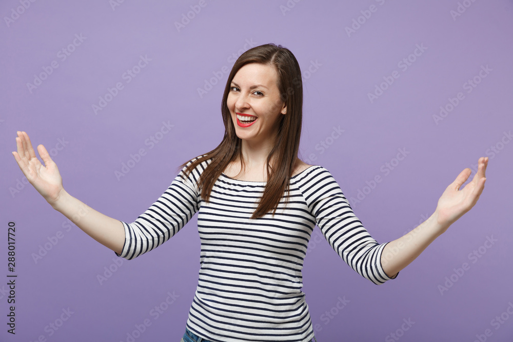 Smiling joyful young woman in casual striped clothes posing isolated on violet purple background. People lifestyle concept. Mock up copy space. Gesturing demonstrating size with horizontal workspace. Smiling joyful young woman in casual striped clothes posing isolated on violet purple background. People lifestyle concept. Mock up copy space. Gesturing demonstrating size with horizontal workspace.
