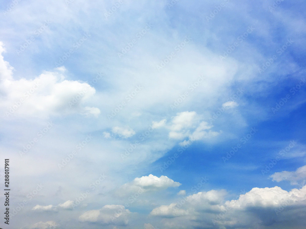 white fluffy clouds on blue sky in summer on sunny day