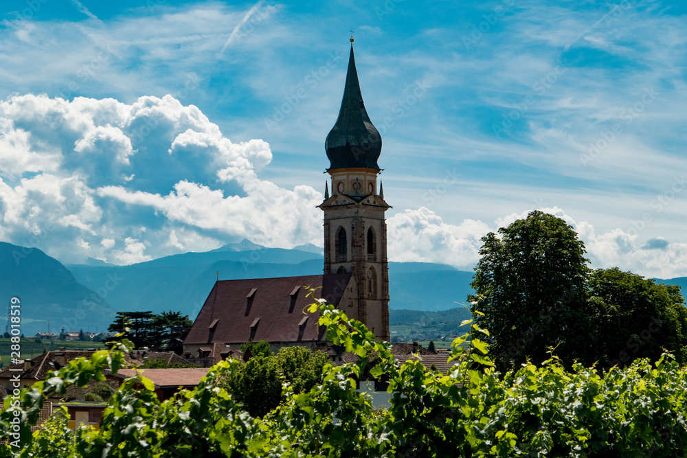 church in south tyrol with cloudy sky and vine yard church in south tyrol with cloudy sky and vine yard