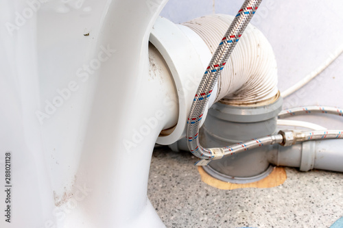 Plastic corrugated pan pipe and water supply fitting for the toilet