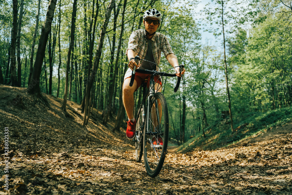 Naklejka premium Men is riding on bicycle.