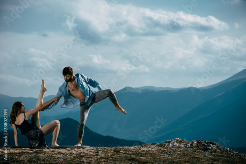 The young attractive modern ballet dancers on mountain hill
