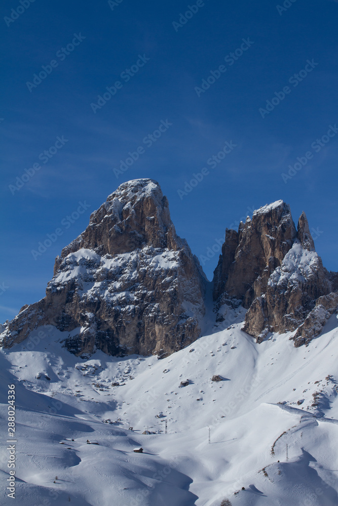 Grohmann Mountain and Cinquedita in the Dolomites above Val Gardena. Mountains covered in Snow in the middle of Winter