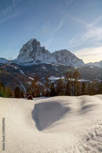 Winter Paradise in the Dolomites, scenic view of the Sassolungo above Selva di Val Gardena and Santa Christina in Gröden. Langkofel covered in Snow