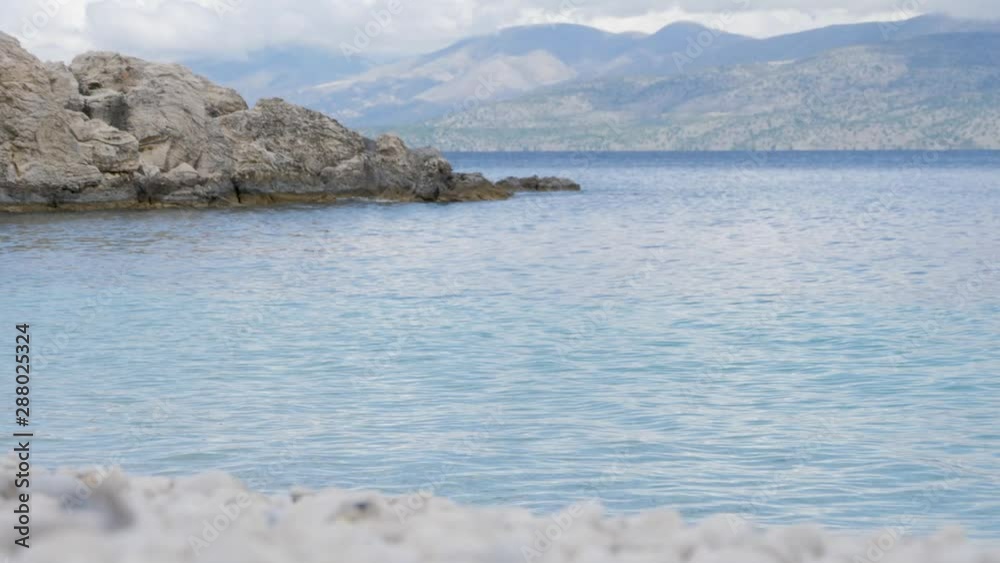 Rack focus to amazing landscape From white pebble beach to bay with rocky coastline. Rack focus to amazing landscape From white pebble beach to bay with rocky coastline.